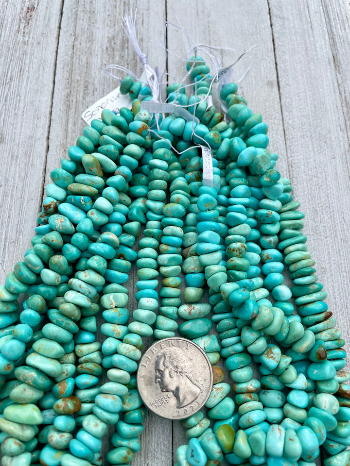 Green Alacran turquoise center drilled nugget strands sold individually. U.S. quarter for size reference. Available only at Rockstar Cowgirl online or in store in Cody, Wyoming.