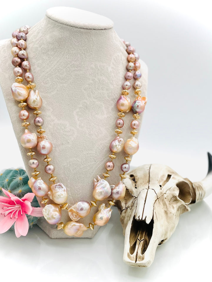 Silk knotted 2 strand necklace featuring flame ball natural luster pearls, smaller pink pearls, 14k gold accents, and finished a small turquoise heart at the back. Available only from Rockstar Cowgirl online or in store in Cody, Wyoming.
