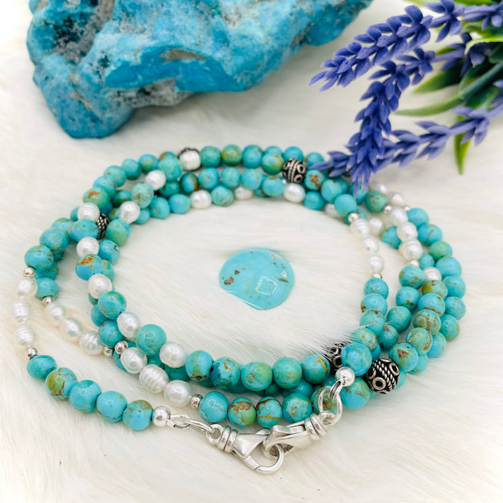 Beaded invention necklace featuring Kingman turquoise, freshwater pearls, sterling sliver accent beads, with sterling silver swivel lobsters, eye glasses loops, and cell phone case attachment bracket. Available only from Rockstar Cowgirl online or in store in Cody, Wyoming. 