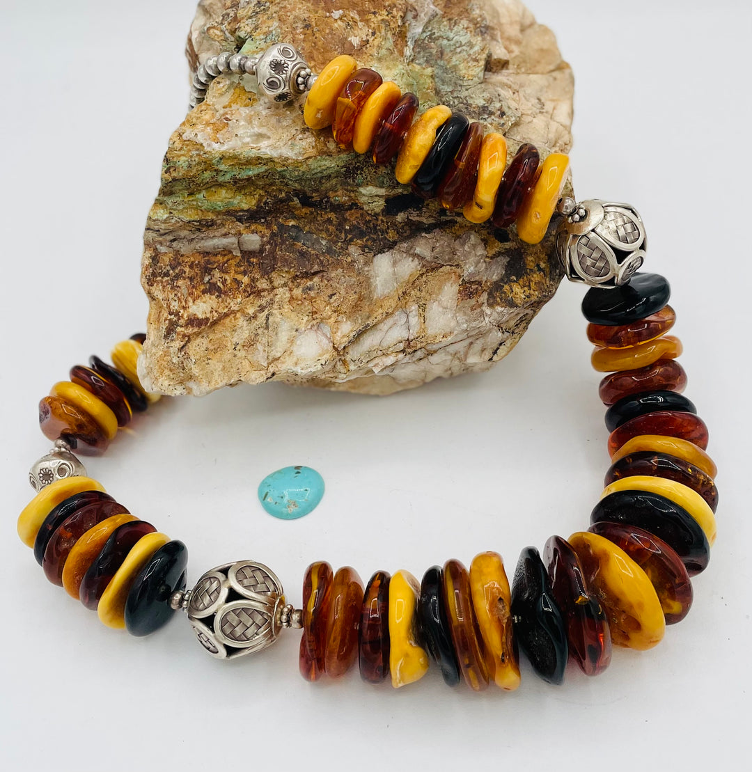 Beaded necklace featuring multi colored Baltic amber discs an handmade sterling silver beads. Available only from Rockstar Cowgirl online or in store in Cody, Wyoming.