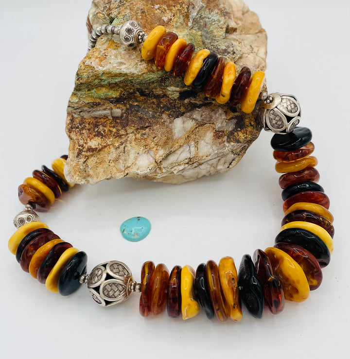 Beaded necklace featuring multi colored Baltic amber discs an handmade sterling silver beads. Available only from Rockstar Cowgirl online or in store in Cody, Wyoming.