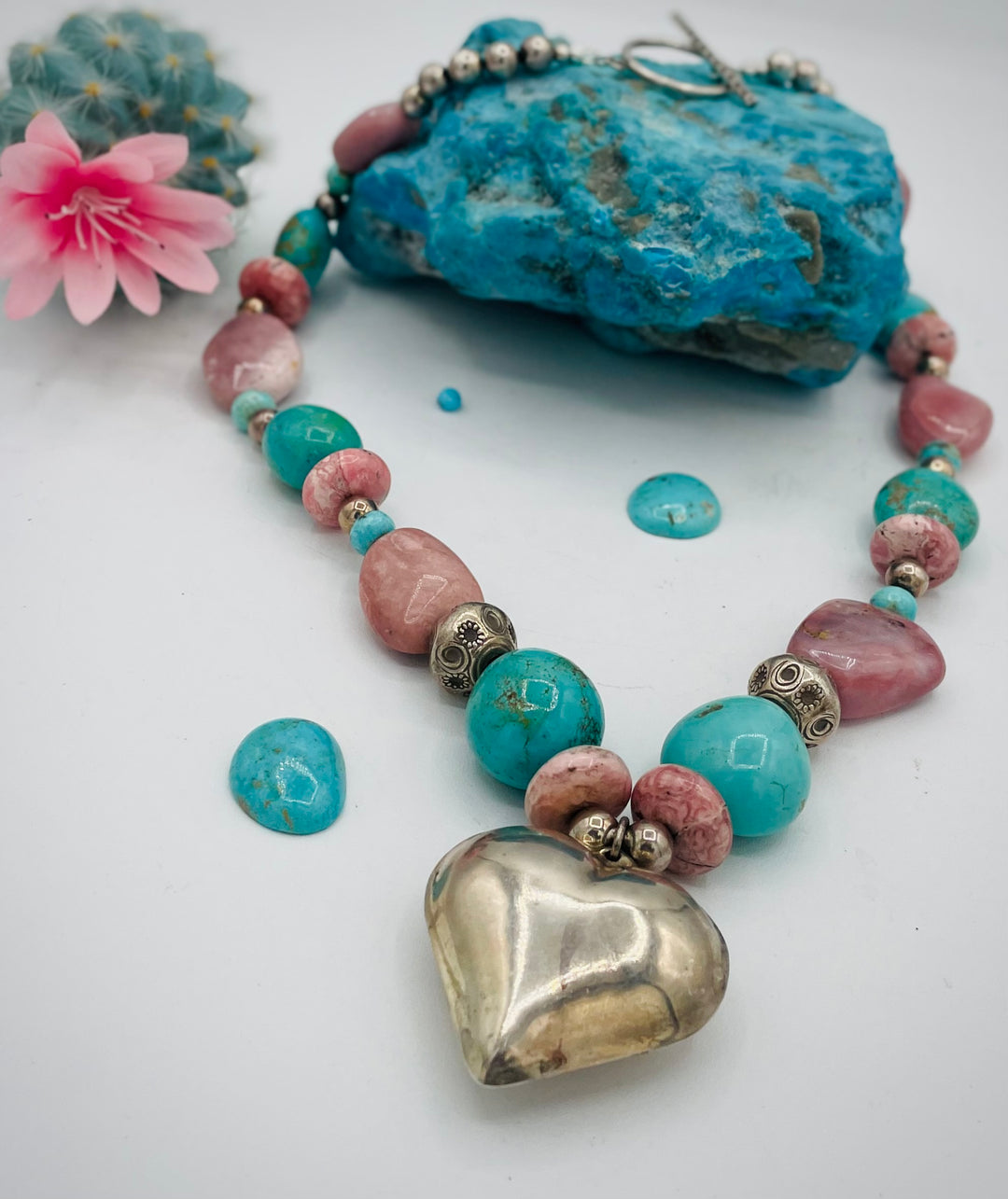 Chunky beaded necklace featuring Pink opal nuggets, rhodochrosite, sterling silver beads, Kingman turquoise nuggets, and sterling silver puffy heart pendent. Available only from Rockstar Cowgirl online or in store in Cody, Wyoming.