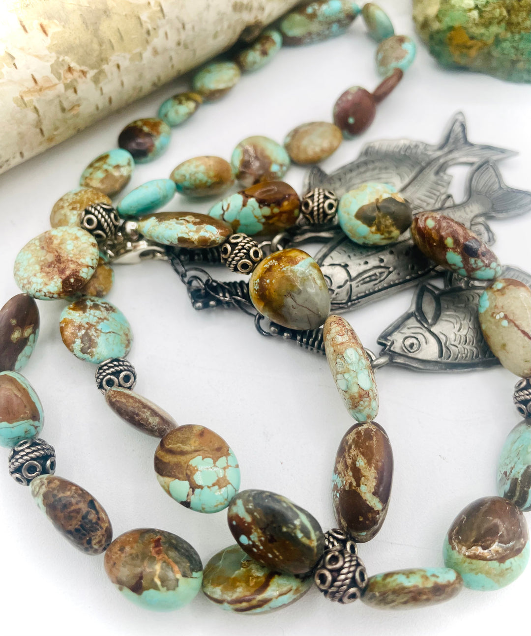 Beaded necklace featuring vintage #8 turquoise nuggets, sterling silver beads, and handmade sterling silver signed fish charms. Marcie. Available only from Rockstar Cowgirl online or in store in Cody, Wyoming.