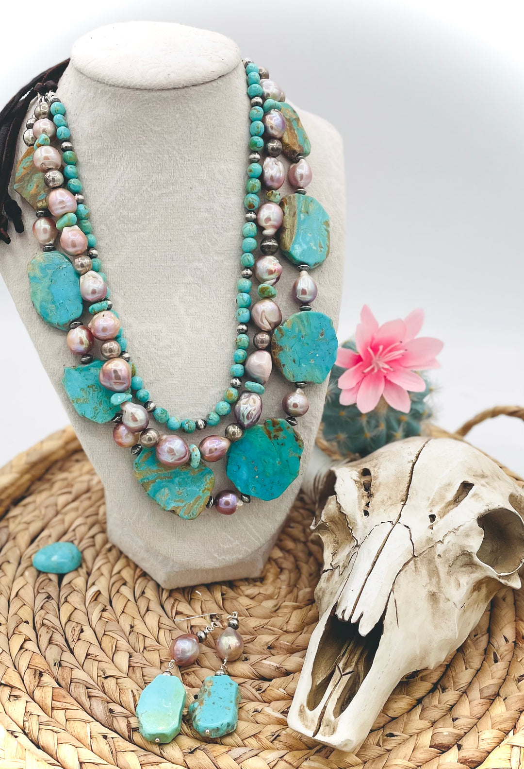 Beaded three strand necklace featuring Kingman turquoise, natural luster pearls, sterling silver beads, and finished with deer lace and slide bead. Includes matching earrings. Available only from Rockstar Cowgirl online or in store in Cody, Wyoming.