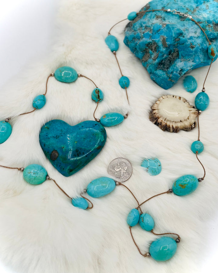 Silk knotted necklace featuring Kingman turquoise nuggets and sterling silver rounds on silk cord. U.S. quarter for size reference. Available only from Rockstar Cowgirl online or in store in Cody, Wyoming.