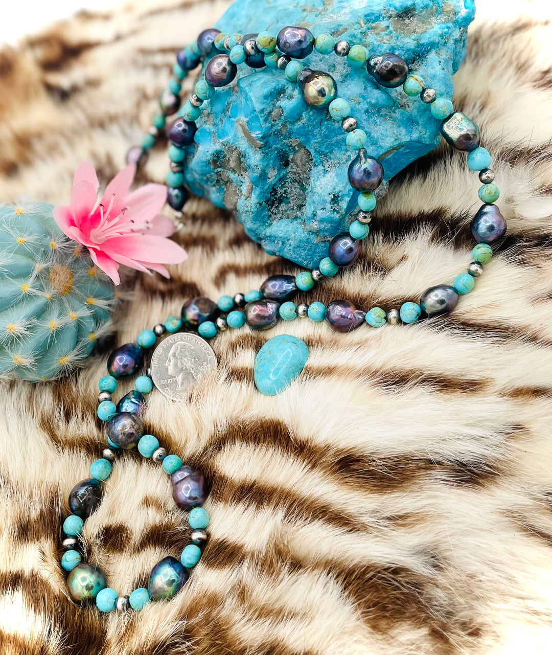 Beaded invention necklace featuring Kingman turquoise, peacock pearls, sterling silver beads, sterling silver swivel lobsters, eyeglass loops, and cell phone case attachment bracket. U.S. quarter for size reference. Available only from Rockstar Cowgirl online or in store in Cody, Wyoming. 