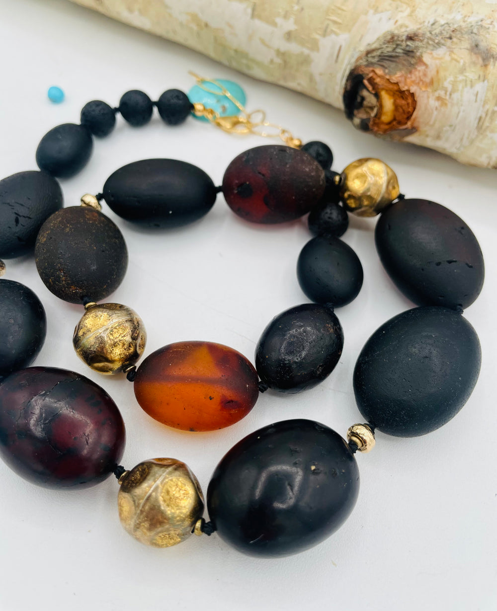 Silk knotted necklace featuring black Baltic amber nuggets, lava, and 14K gold beads. Available only from Rockstar Cowgirl online or in store in Cody, Wyoming.