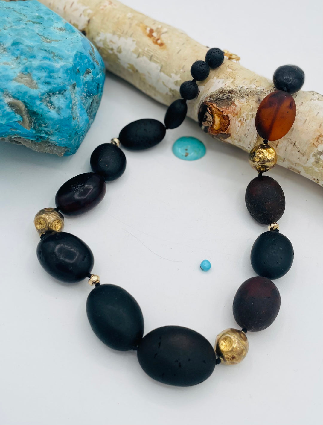 Silk knotted necklace featuring black Baltic amber nuggets, lava, and 14K gold beads. Available only from Rockstar Cowgirl online or in store in Cody, Wyoming.
