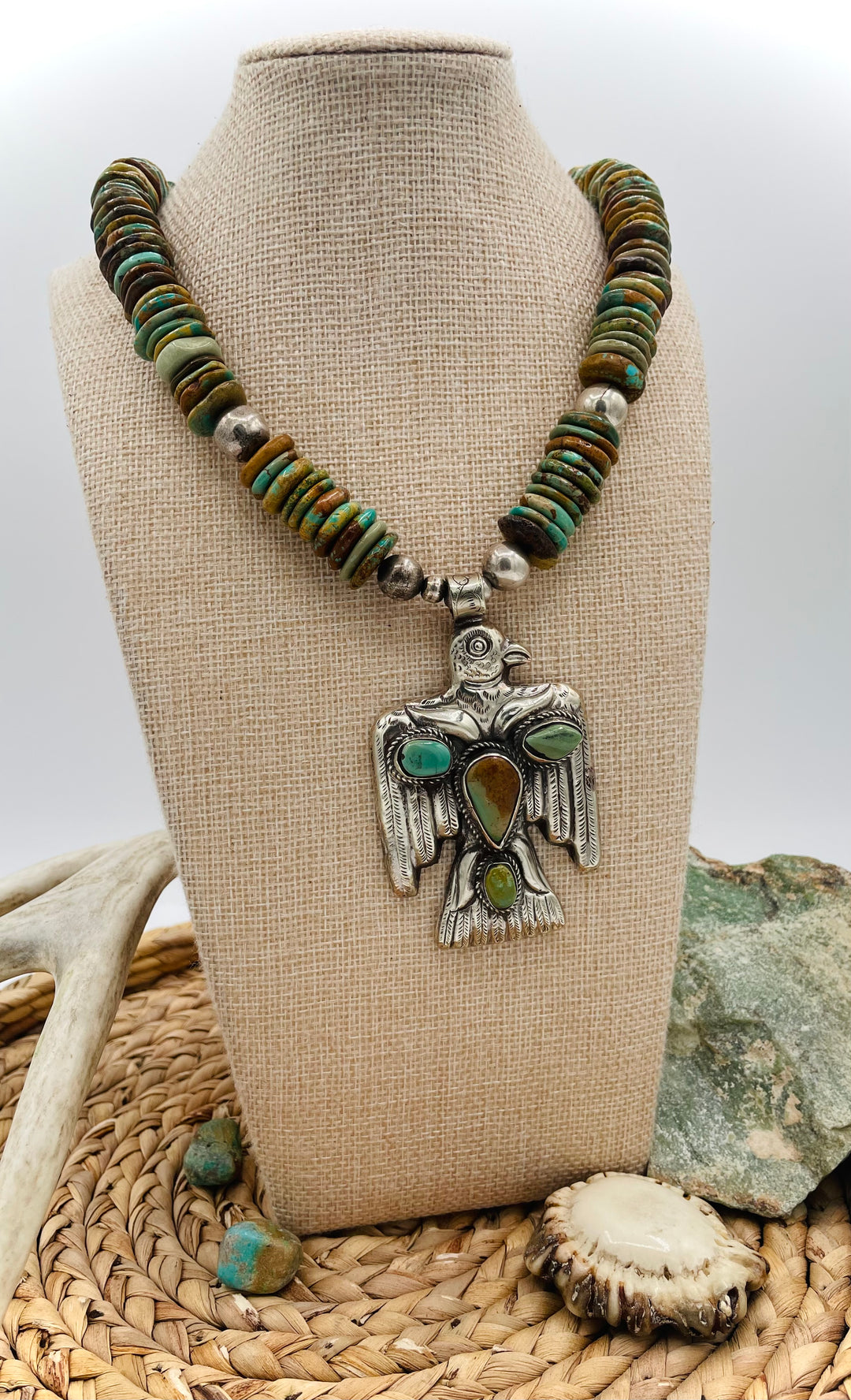 Handmade turquoise necklace featuring  turquoise discs, sterling silver accents, and Tibetan silver pendent. Available only from Rockstar Cowgirl online or in store in Cody, Wyoming.