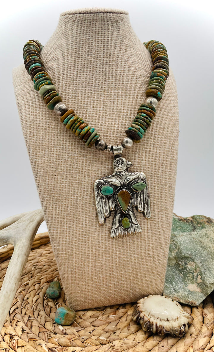 Handmade turquoise necklace featuring  turquoise discs, sterling silver accents, and Tibetan silver pendent. Available only from Rockstar Cowgirl online or in store in Cody, Wyoming.