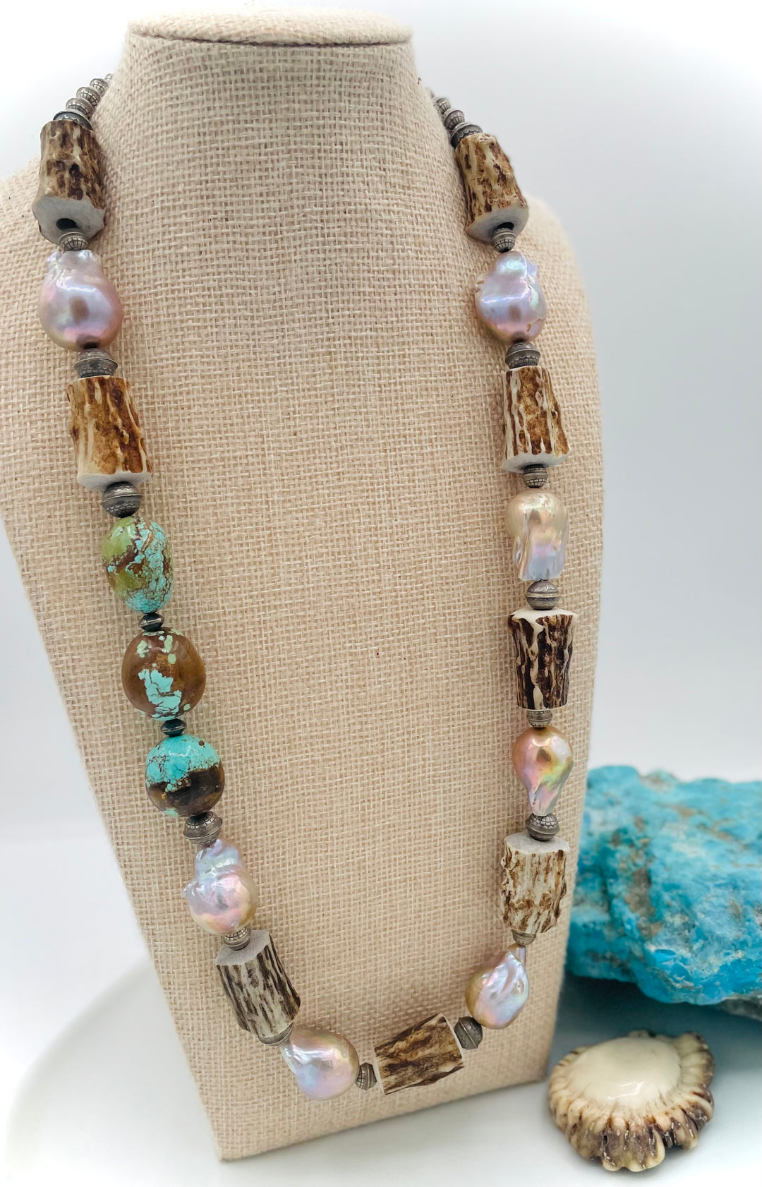 Handmade beaded necklace featuring textured deer antler beads, #8 turquoise nuggets, natural luster flameball pearls, and sterling silver beads. Available only from Rockstar Cowgirl online or in store in Cody, Wyoming. 
