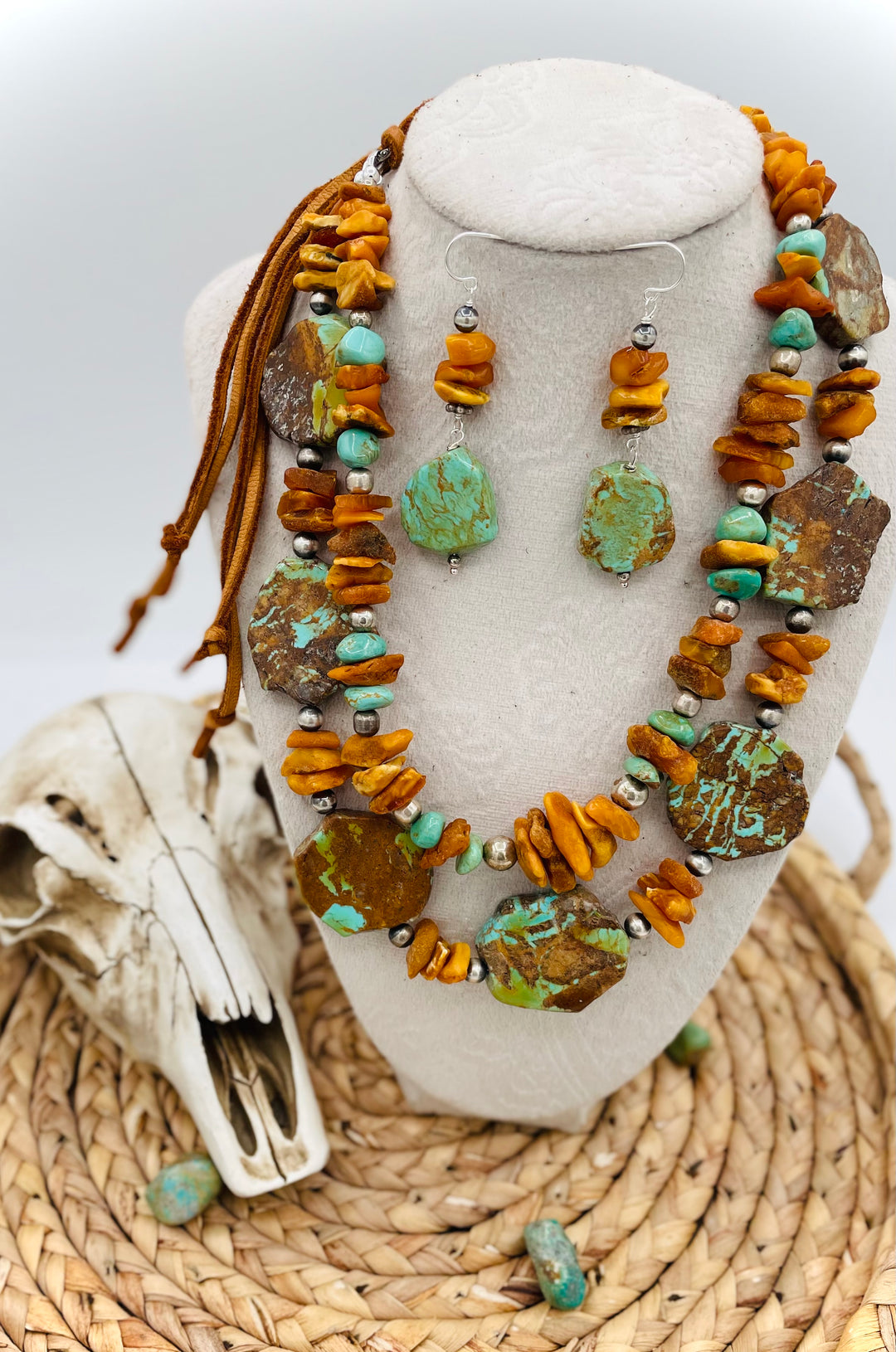 Beaded three strand necklace featuring Kingman turquoise, butterscotch amber, sterling silver beads, deer lace, and slide bead. Includes matching earrings. Available only from Rockstar Cowgirl online or in store in Cody, Wyoming.