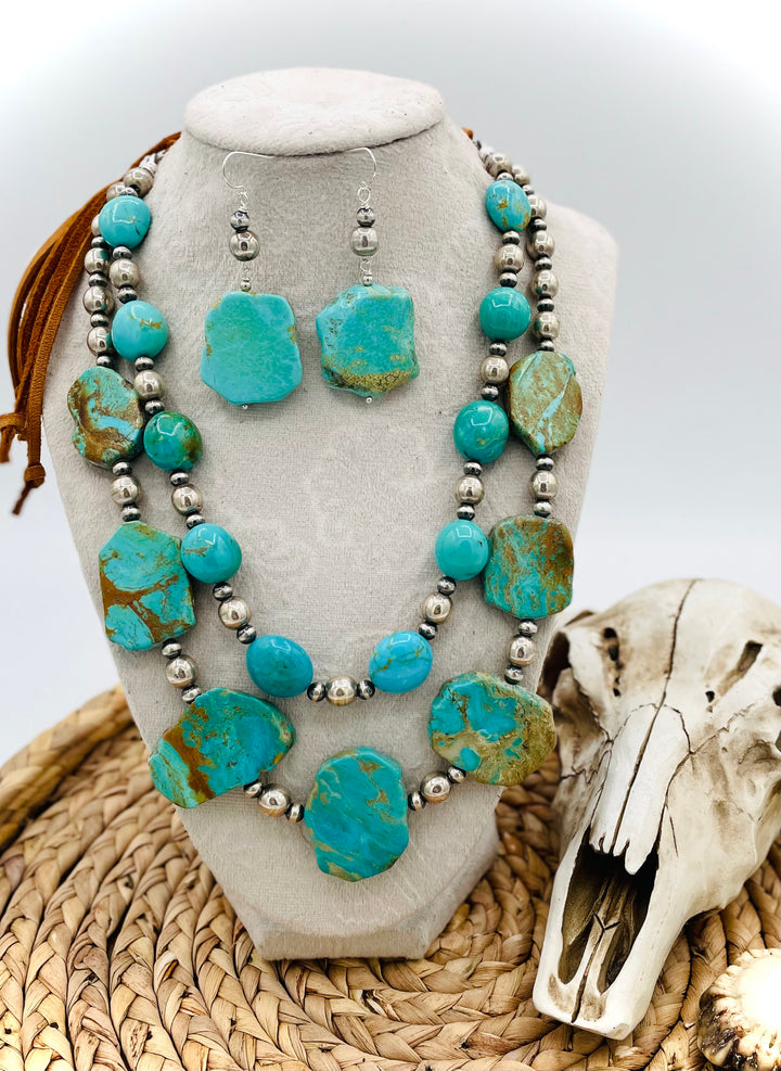 Beaded two strand necklace featuring Kingman turquoise and sterling silver beads and finished with  deer lace and slide bead. Including matching earrings. Available only from Rockstar Cowgirl online or in store in Cody, Wyoming.
