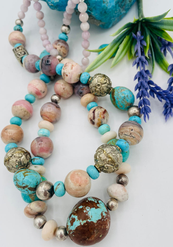 Adjustable beaded necklace featuring Pink opal, Royal beauty turquoise, Serling silver beads, Kingman turquoise, Repousse beads, pink morganite, number 8 turquoise nuggets, and finished with deer leather lace. Available only from Rockstar Cowgirl online or in store in Cody, Wyoming.