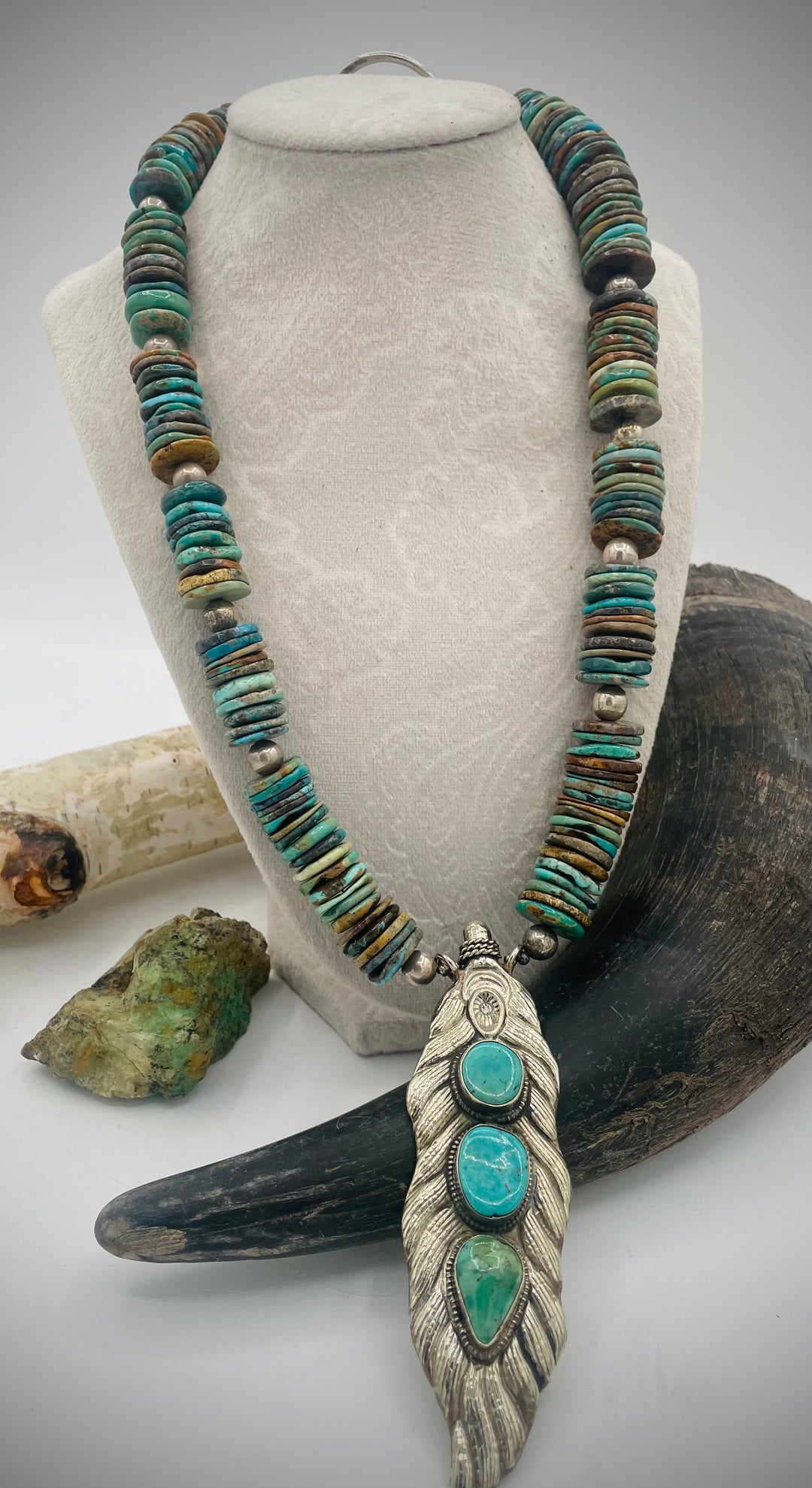 Handmade beaded necklace featuring turquoise discs, sterling silver beads, and Tibetan silver pendent with turquoise inlays. Available only from Rockstar Cowgirl online or in store in Cody, Wyoming.