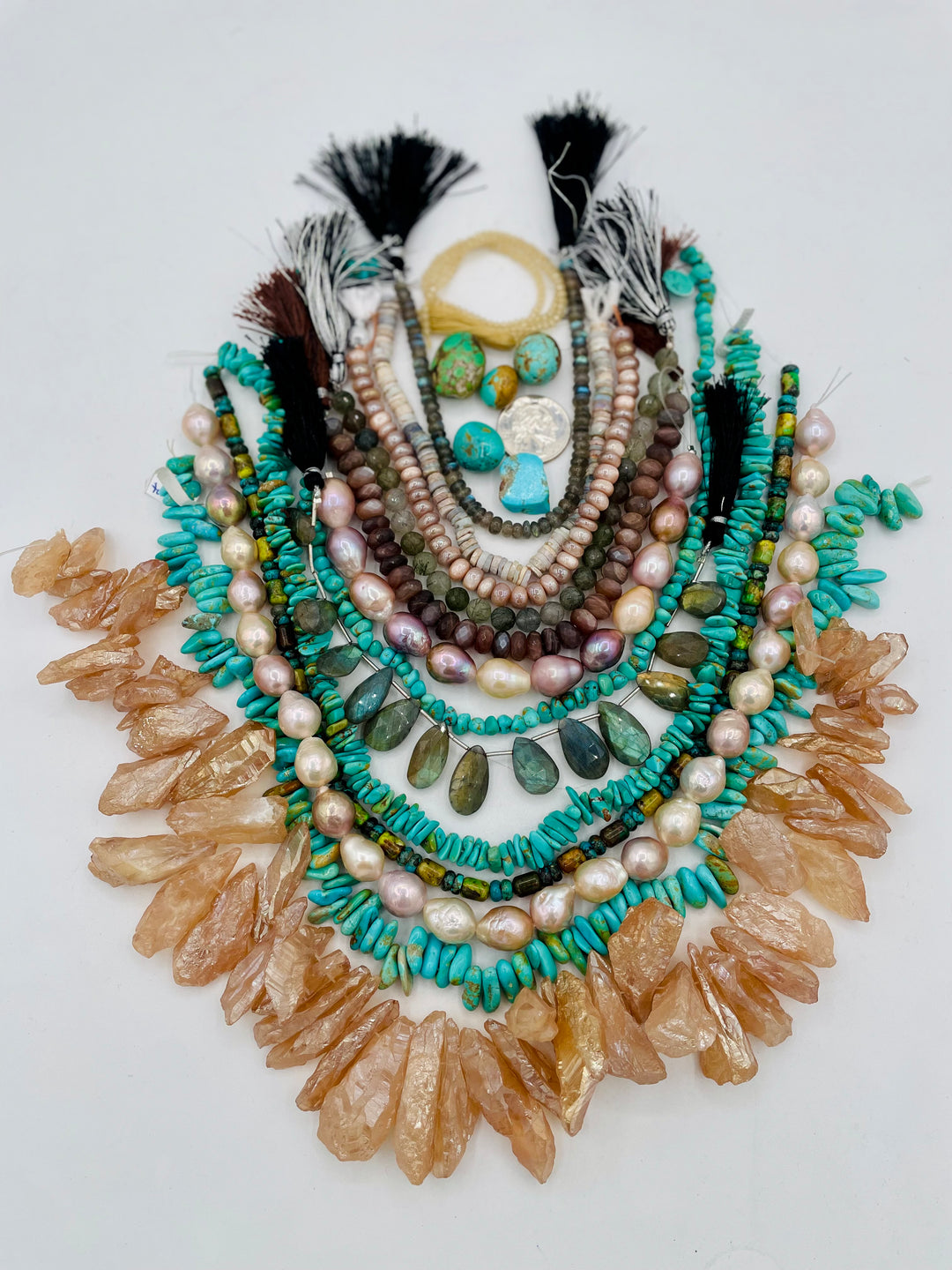 Curated bead box featuring Sonoran turquoise, Kingman turquoise, Hubei turquoise, #8 turquoise, high grade pearls, labradorite, quartz, and moonstone.  143 grams of turquoise. Includes strands and pendent sized nuggets. U.S. quarter for size reference. Available only from Rockstar Cowgirl online or in store in Cody, Wyoming.