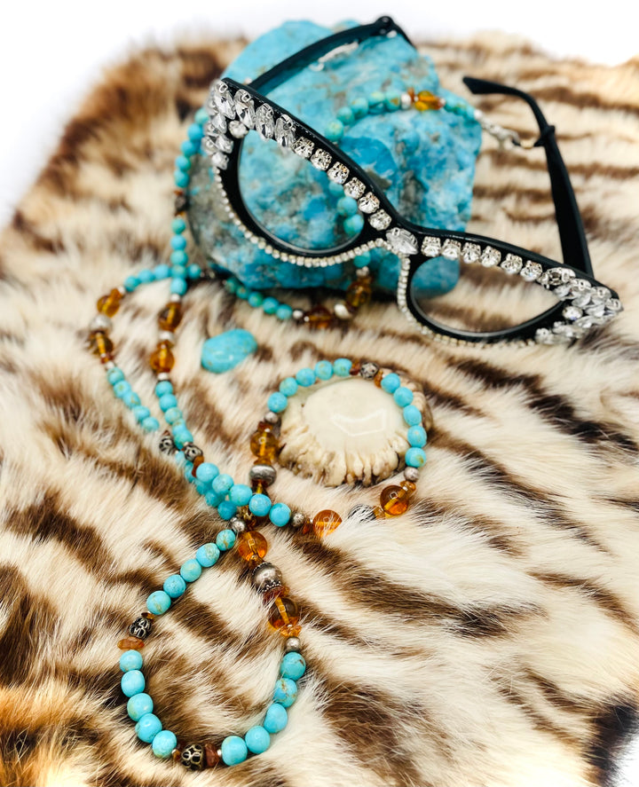 Beaded invention necklace featuring Kingman turquoise, Baltic amber, citrine, sterling silver and African silver accents with sterling silver swivel lobsters, eye glasses loops, cell phone case attachment bracket. Available only from Rockstar Cowgirl online or in store in Cody, Wyoming.