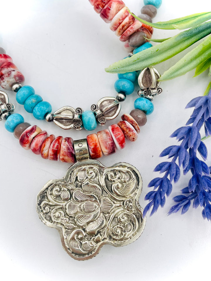 Beaded 2 strand necklace featuring spiny oyster, royal beauty turquoise, brown moonstone, and sterling silver beads with a spiny oyster flower pendent. Available only from Rockstar Cowgirl online or in store in Cody, Wyoming.