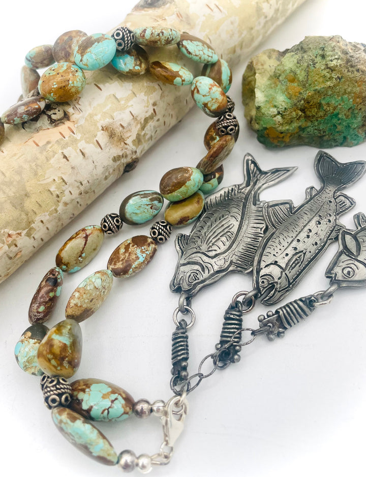 Beaded necklace featuring vintage #8 turquoise nuggets, sterling silver beads, and handmade sterling silver signed fish charms. Marcie. Available only from Rockstar Cowgirl online or in store in Cody, Wyoming.