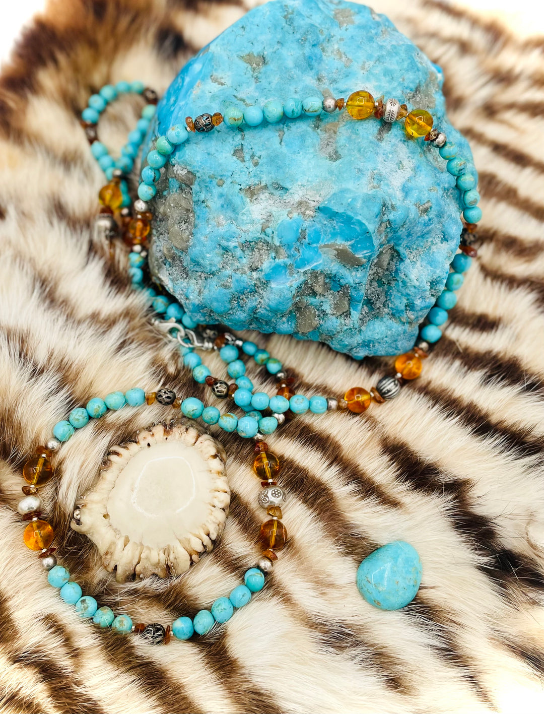 Beaded invention necklace featuring Kingman turquoise, Baltic amber, citrine, sterling silver and African silver accents with sterling silver swivel lobsters, eye glasses loops, cell phone case attachment bracket. Available only from Rockstar Cowgirl online or in store in Cody, Wyoming.
