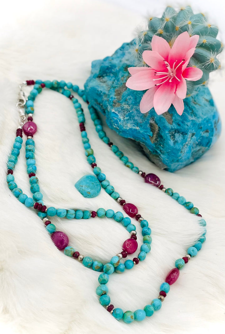 Beaded necklace, phone holder strap, or eye glass holder featuring blue Kingman turquoise, pink ruby nuggets and rondelles, sterling silver and African silver beads, sterling silver swivel lobsters, phone case attachments,  and glasses loops. Available only from Rockstar Cowgirl online or in store in Cody, Wyoming.