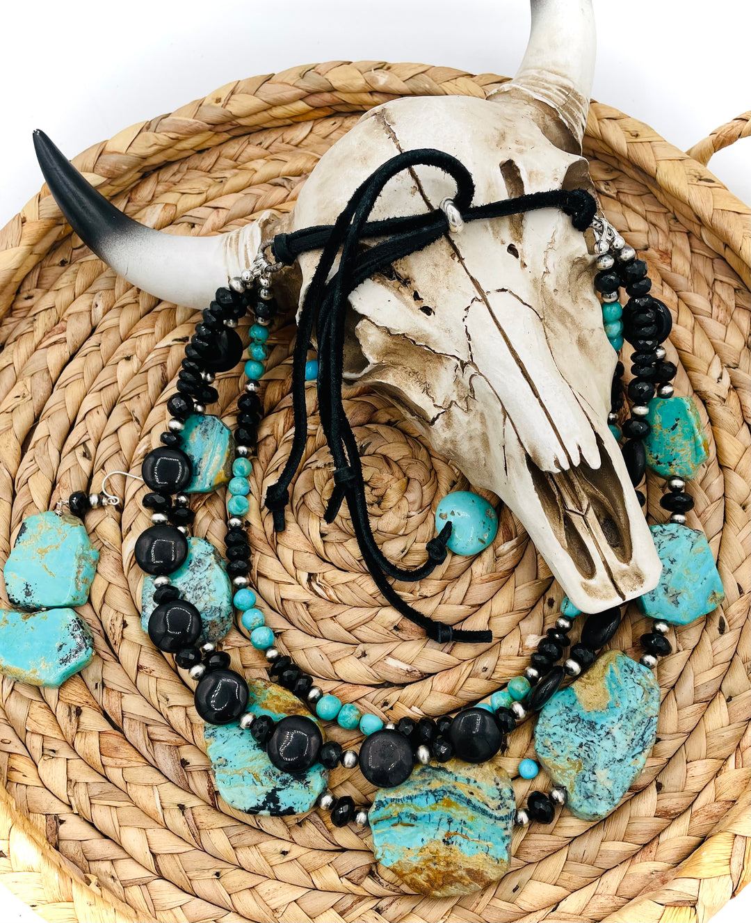 Beaded three strand necklace featuring Kingman turquoise, onyx, spinel, sterling silver, and finished with deer lace and slide bead. Includes matching earrings. Available only from Rockstar Cowgirl online or in store in Cody, Wyoming.
