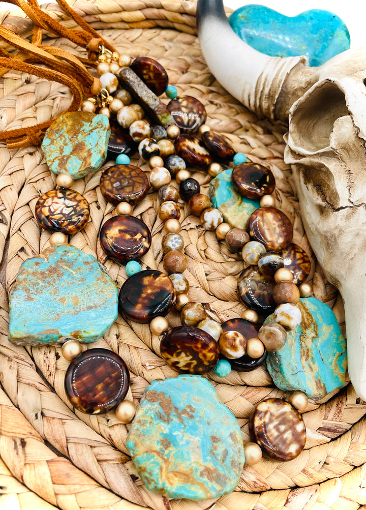 Beaded three strand necklace featuring Kingman turquoise, fire agate, gold hematite, deer lace, and slide bead. Includes matching earrings. Available only from Rockstar Cowgirl online or in store in Cody, Wyoming.