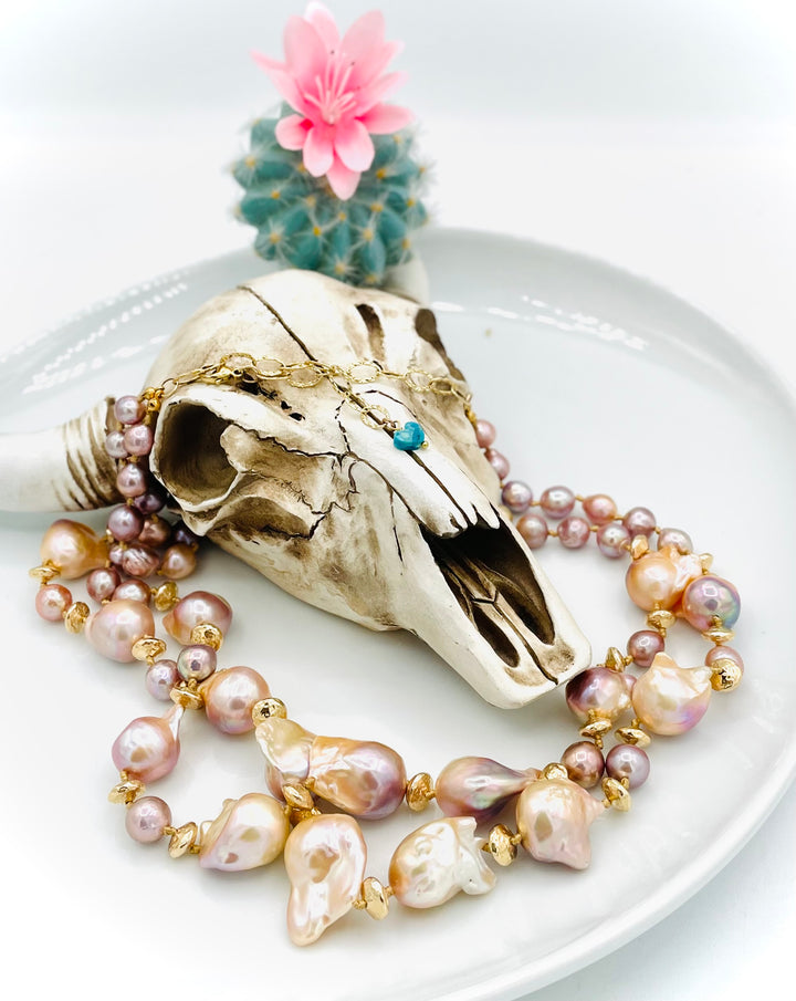 Silk knotted 2 strand necklace featuring flame ball natural luster pearls, smaller pink pearls, 14k gold accents, and finished a small turquoise heart at the back. Available only from Rockstar Cowgirl online or in store in Cody, Wyoming.
