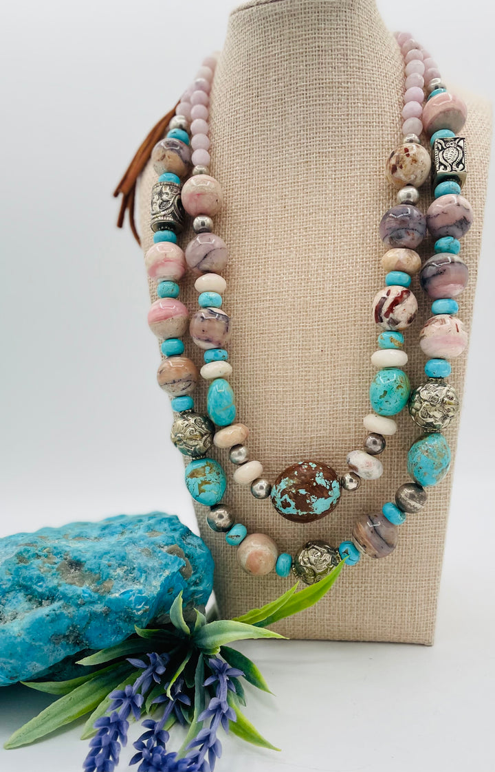 Adjustable beaded necklace featuring Pink opal, Royal beauty turquoise, Serling silver beads, Kingman turquoise, Repousse beads, pink morganite, number 8 turquoise nuggets, and finished with deer leather lace. Available only from Rockstar Cowgirl online or in store in Cody, Wyoming.