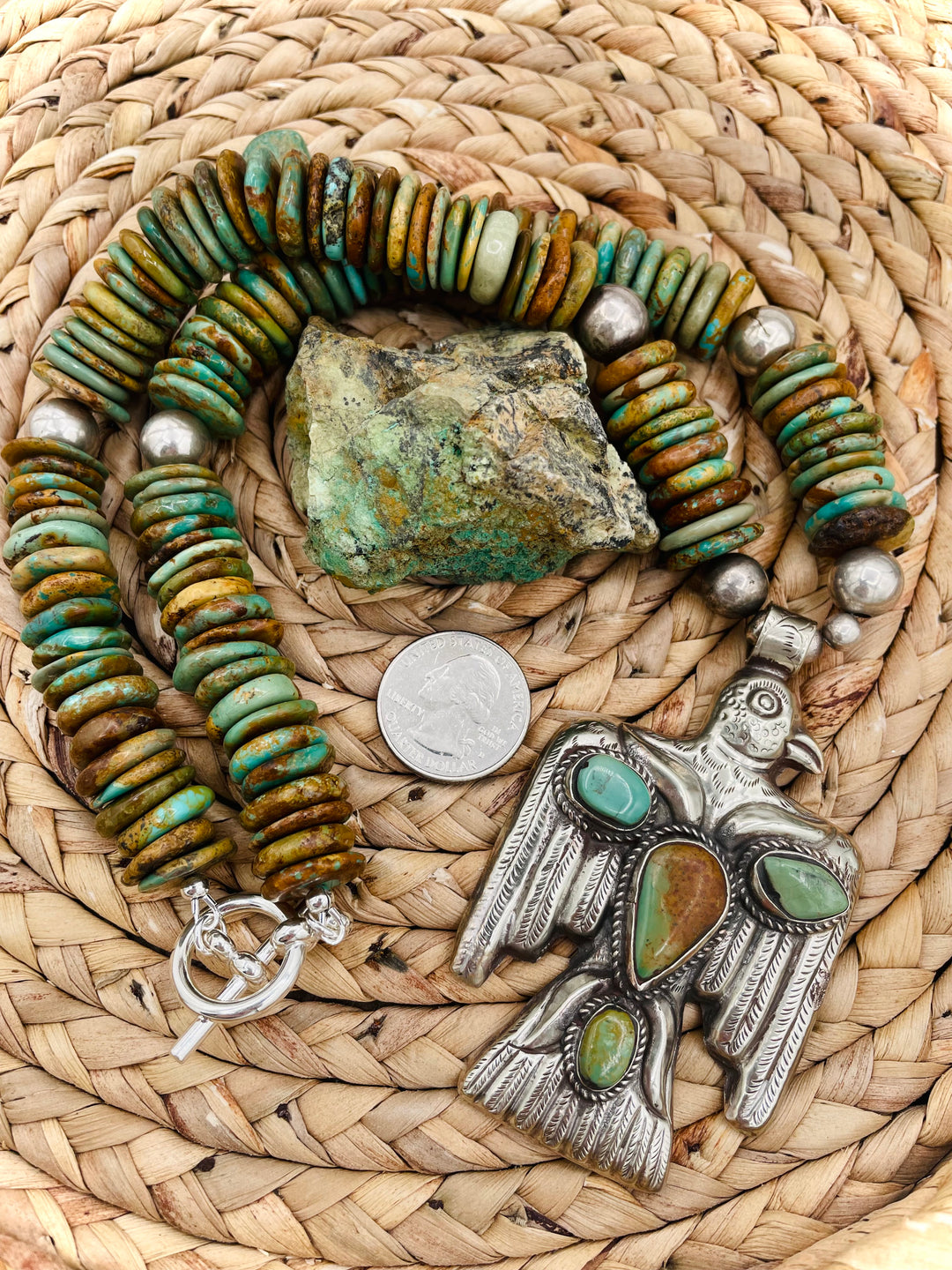 Handmade turquoise necklace featuring  turquoise discs, sterling silver accents, and Tibetan silver pendent. U.S. quarter for size reference. Available only from Rockstar Cowgirl online or in store in Cody, Wyoming.
