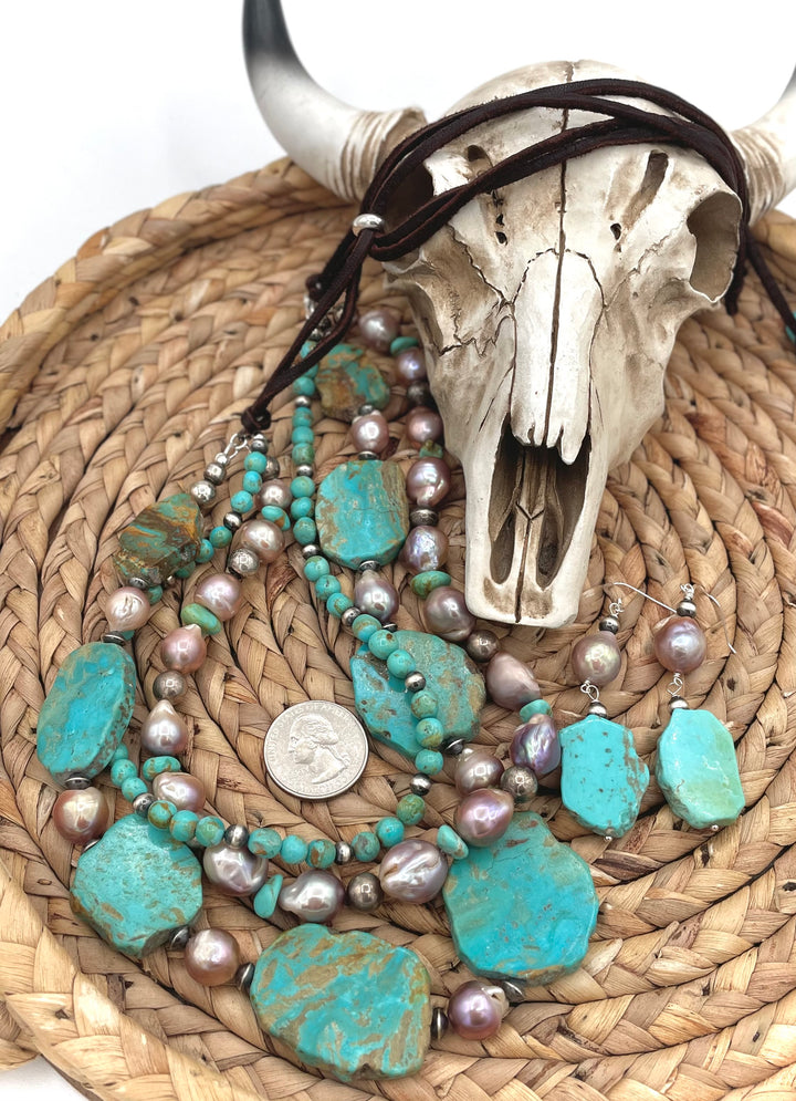 Beaded three strand necklace featuring Kingman turquoise, natural luster pearls, sterling silver beads, and finished with deer lace and slide bead. Includes matching earrings. U.S. quarter for size reference. Available only from Rockstar Cowgirl online or in store in Cody, Wyoming.