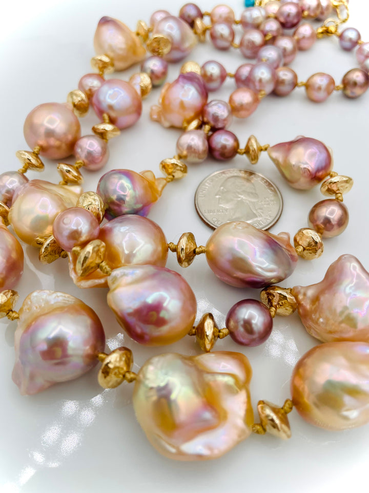 Silk knotted 2 strand necklace featuring flame ball natural luster pearls, smaller pink pearls, 14k gold accents, and finished a small turquoise heart at the back. U.S. quarter for size reference. Available only from Rockstar Cowgirl online or in store in Cody, Wyoming.