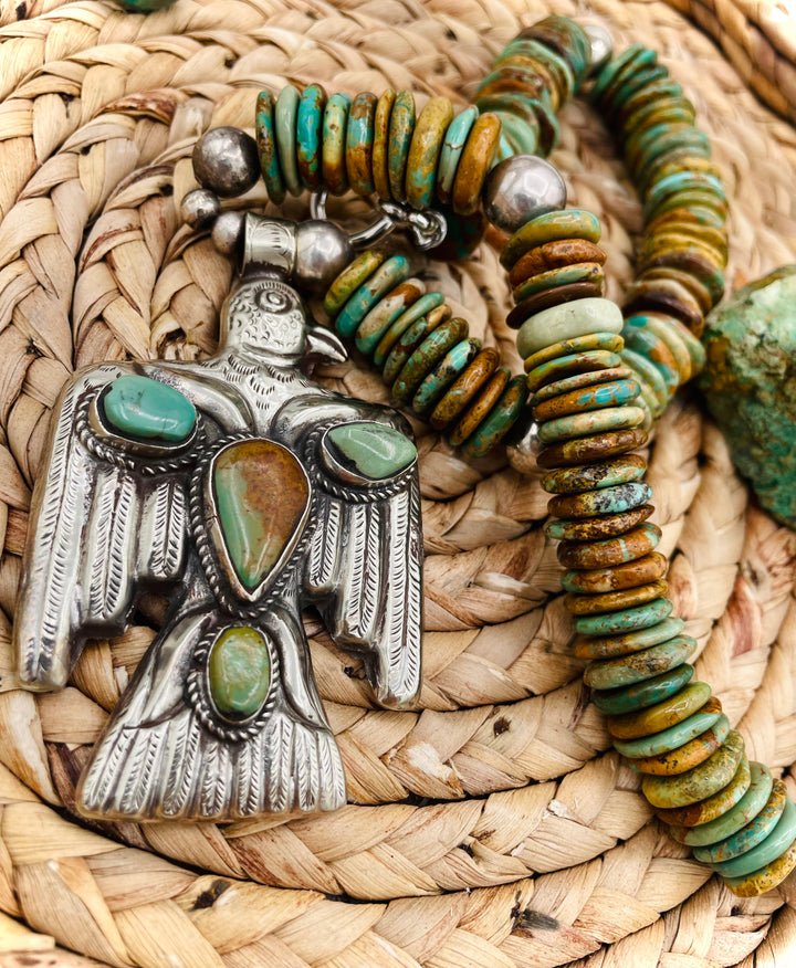 Handmade turquoise necklace featuring  turquoise discs, sterling silver accents, and Tibetan silver pendent. Available only from Rockstar Cowgirl online or in store in Cody, Wyoming.