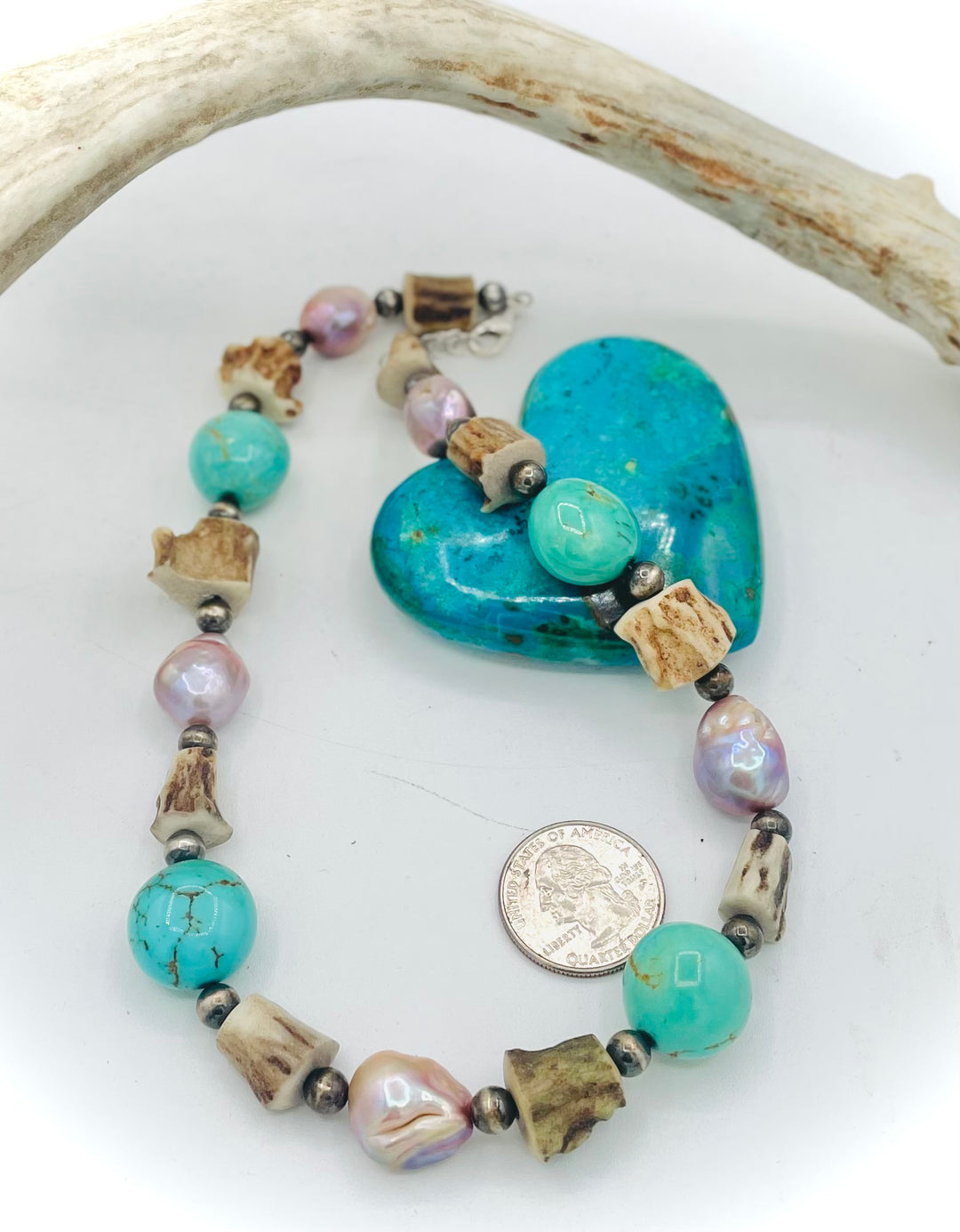 Handmade beaded necklace featuring Kingman turquoise nuggets, deer antler beads, natural luster baroque pearls, and sterling silver beads. U.S. quarter for size reference. Available only from Rockstar Cowgirl online or in store in Cody, Wyoming.