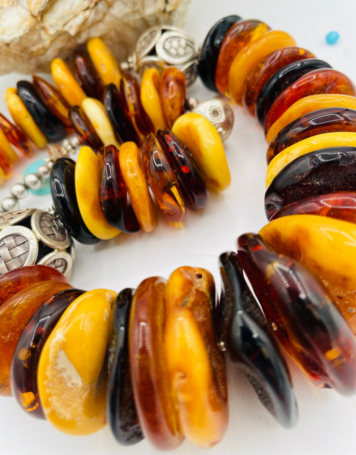 Beaded necklace featuring multi colored Baltic amber discs an handmade sterling silver beads. Available only from Rockstar Cowgirl online or in store in Cody, Wyoming.