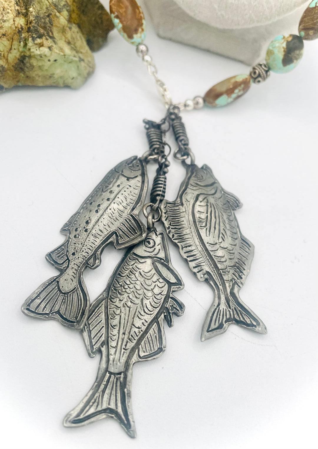 Beaded necklace featuring vintage #8 turquoise nuggets, sterling silver beads, and handmade sterling silver signed fish charms. Marcie. Available only from Rockstar Cowgirl online or in store in Cody, Wyoming.