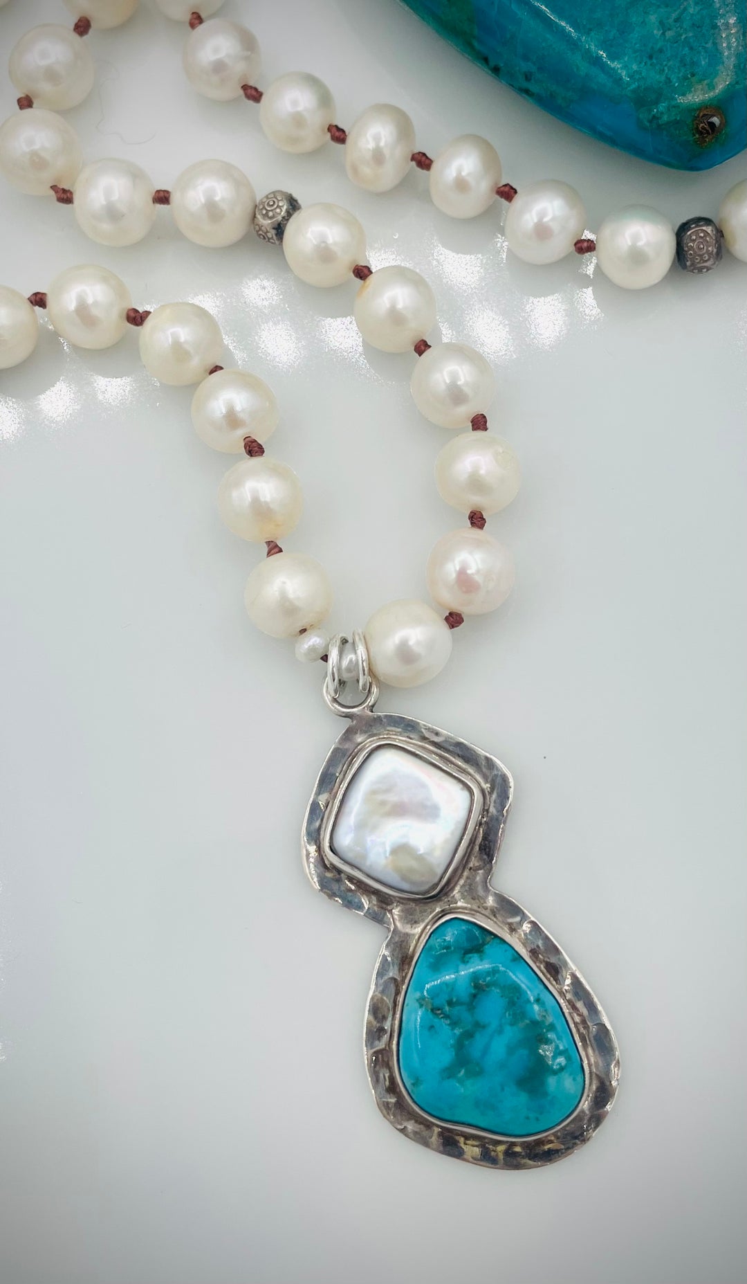 Silk knotted long necklace featuring white pearls, and sterling silver beads with a pearl and turquoise sterling silver pendent. Available only from Rockstar Cowgirl online or in store in Cody, Wyoming.