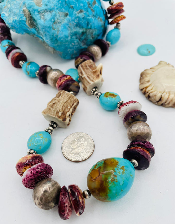 Beaded necklace featuring Antler beads, purple spiney oyster, Kingman turquoise nuggets, and sterling silver beads. U.S. quarter for size reference. Available only from Rockstar Cowgirl online or in store in Cody, Wyoming.