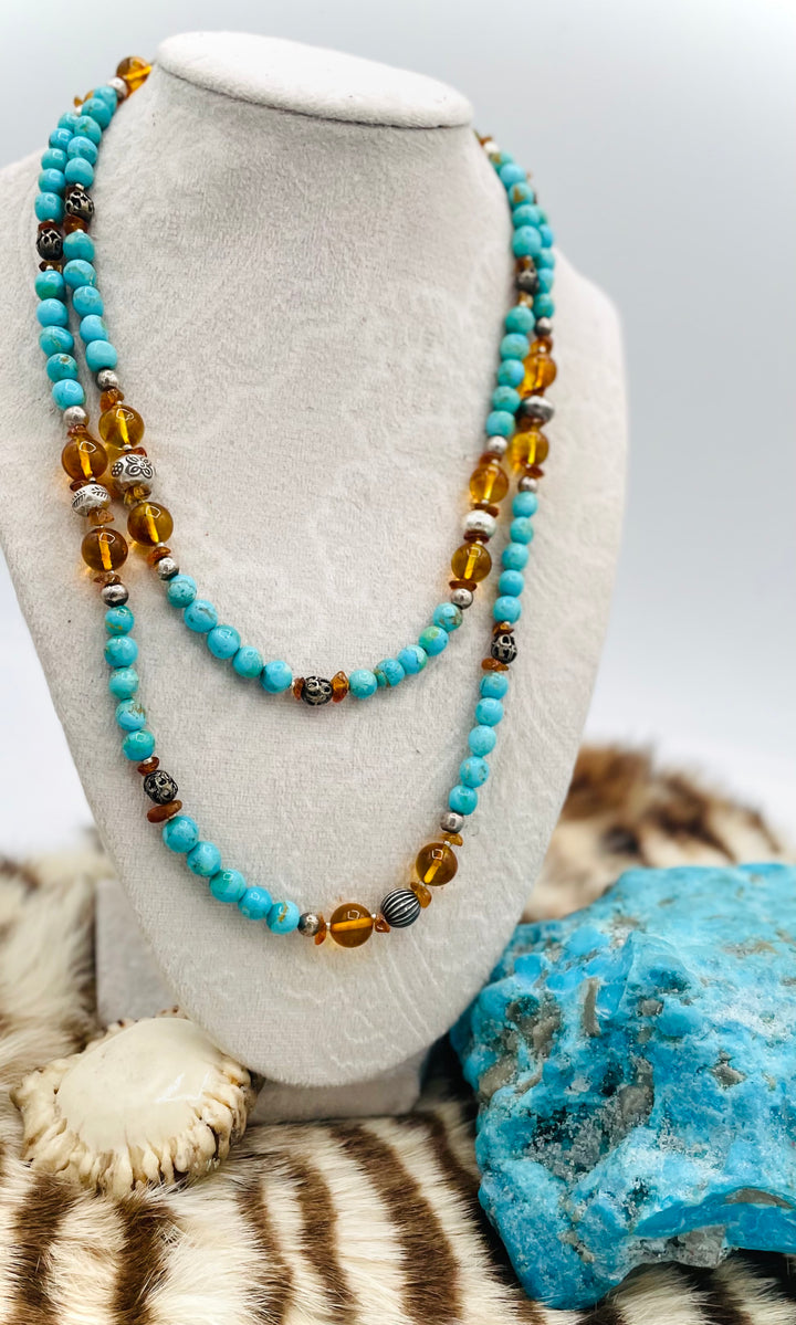 Beaded invention necklace featuring Kingman turquoise, Baltic amber, citrine, sterling silver and African silver accents with sterling silver swivel lobsters, eye glasses loops, cell phone case attachment bracket. Available only from Rockstar Cowgirl online or in store in Cody, Wyoming.