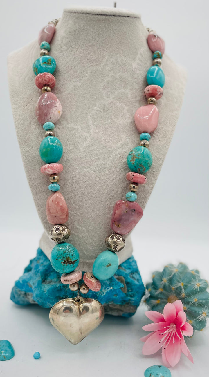 Chunky beaded necklace featuring Pink opal nuggets, rhodochrosite, sterling silver beads, Kingman turquoise nuggets, and sterling silver puffy heart pendent. Available only from Rockstar Cowgirl online or in store in Cody, Wyoming.