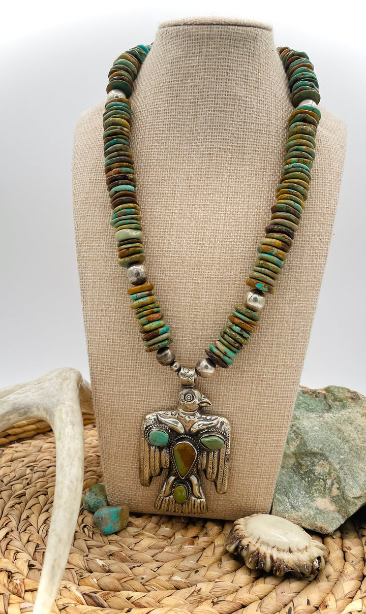 Handmade turquoise necklace featuring  turquoise discs, sterling silver accents, and Tibetan silver pendent. Available only from Rockstar Cowgirl online or in store in Cody, Wyoming.