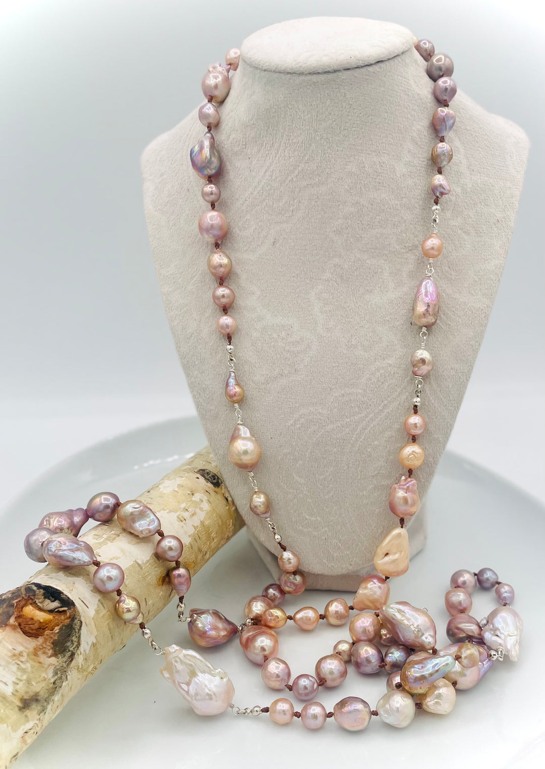 Silk knotted and wire wrapped long treasure necklace featuring natural luster, baroque, Flameball, and Edison pearls with sterling silver accents. Available only from Rockstar Cowgirl online or in store in Cody, Wyoming.