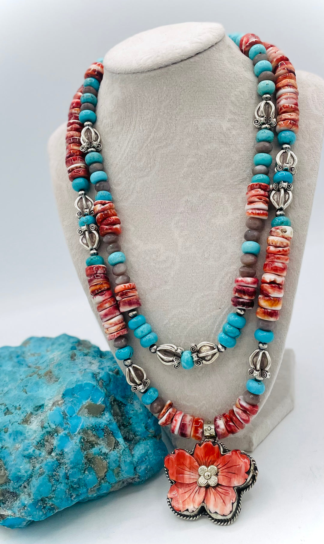 Beaded 2 strand necklace featuring spiny oyster, royal beauty turquoise, brown moonstone, and sterling silver beads with a spiny oyster flower pendent. Available only from Rockstar Cowgirl online or in store in Cody, Wyoming.