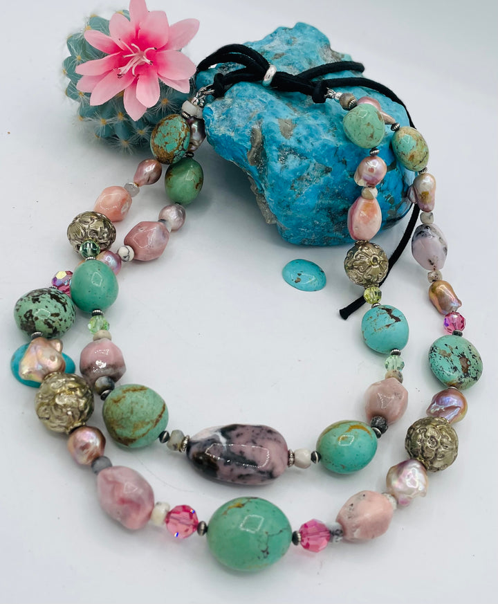 Adjustable beaded necklace featuring Kingman turquoise nuggets, pink opal, pearls, Swarovski crystals, dendrite opal, sterling silver beads, repousse beads, and finished with deer lace and slide bead. Available only from Rockstar Cowgirl online or in store in Cody, Wyoming.