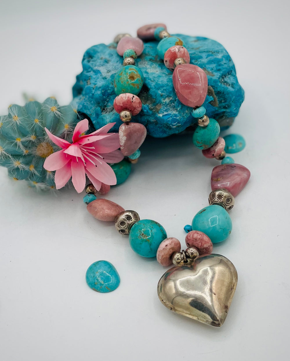 Chunky beaded necklace featuring Pink opal nuggets, rhodochrosite, sterling silver beads, Kingman turquoise nuggets, and sterling silver puffy heart pendent. Available only from Rockstar Cowgirl online or in store in Cody, Wyoming.