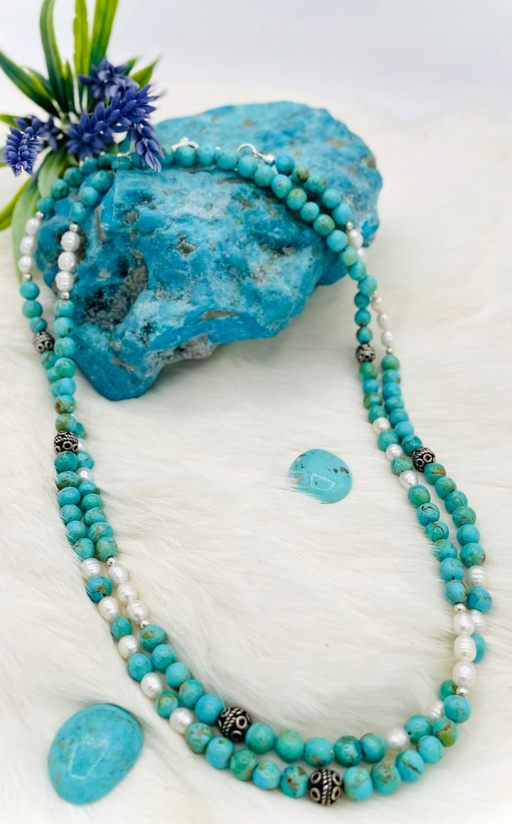 Beaded invention necklace featuring Kingman turquoise, freshwater pearls, sterling sliver accent beads, with sterling silver swivel lobsters, eye glasses loops, and cell phone case attachment bracket. Available only from Rockstar Cowgirl online or in store in Cody, Wyoming. 