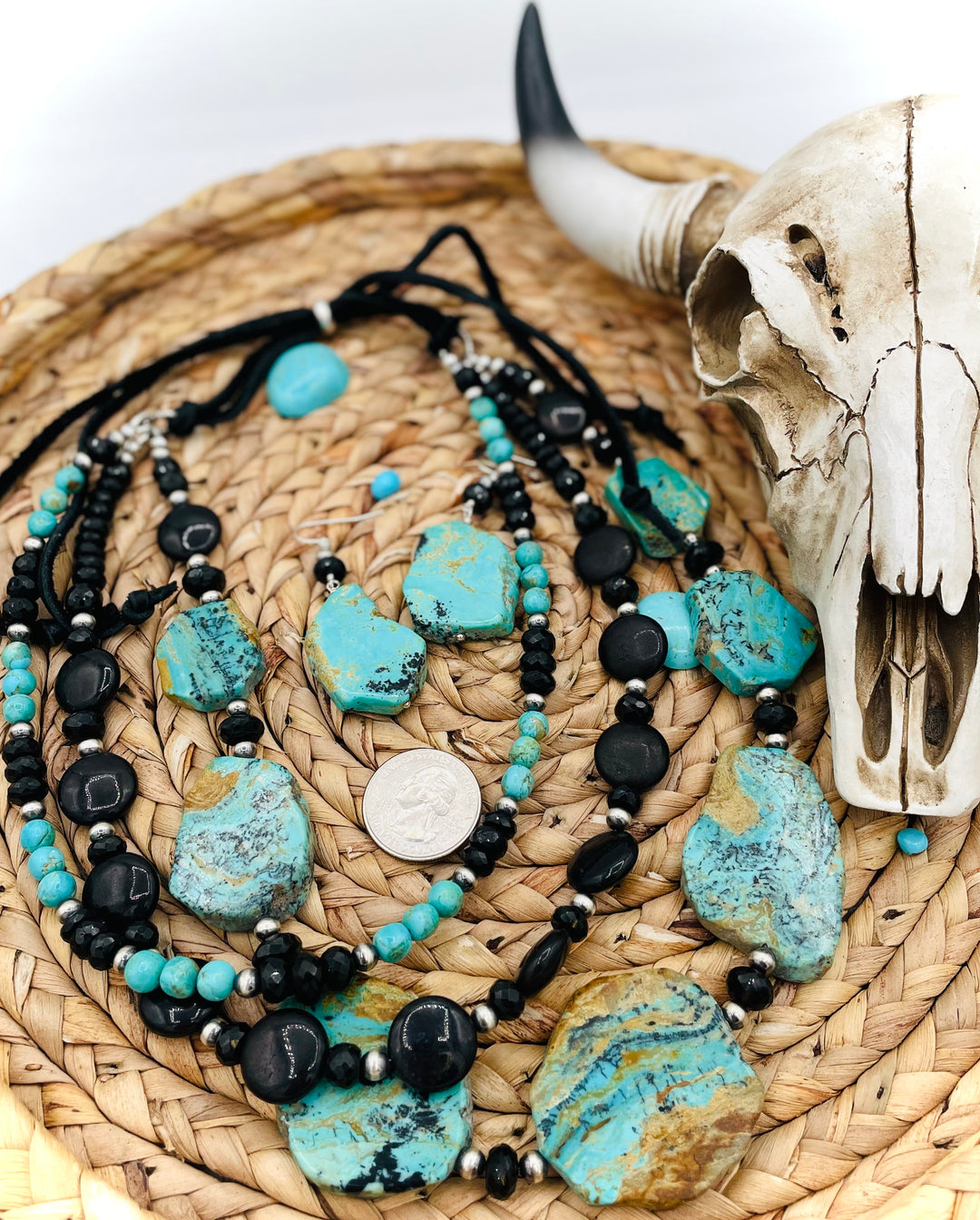 Beaded three strand necklace featuring Kingman turquoise, onyx, spinel, sterling silver, and finished with deer lace and slide bead. Includes matching earrings. U.S. quarter for size reference. Available only from Rockstar Cowgirl online or in store in Cody, Wyoming.