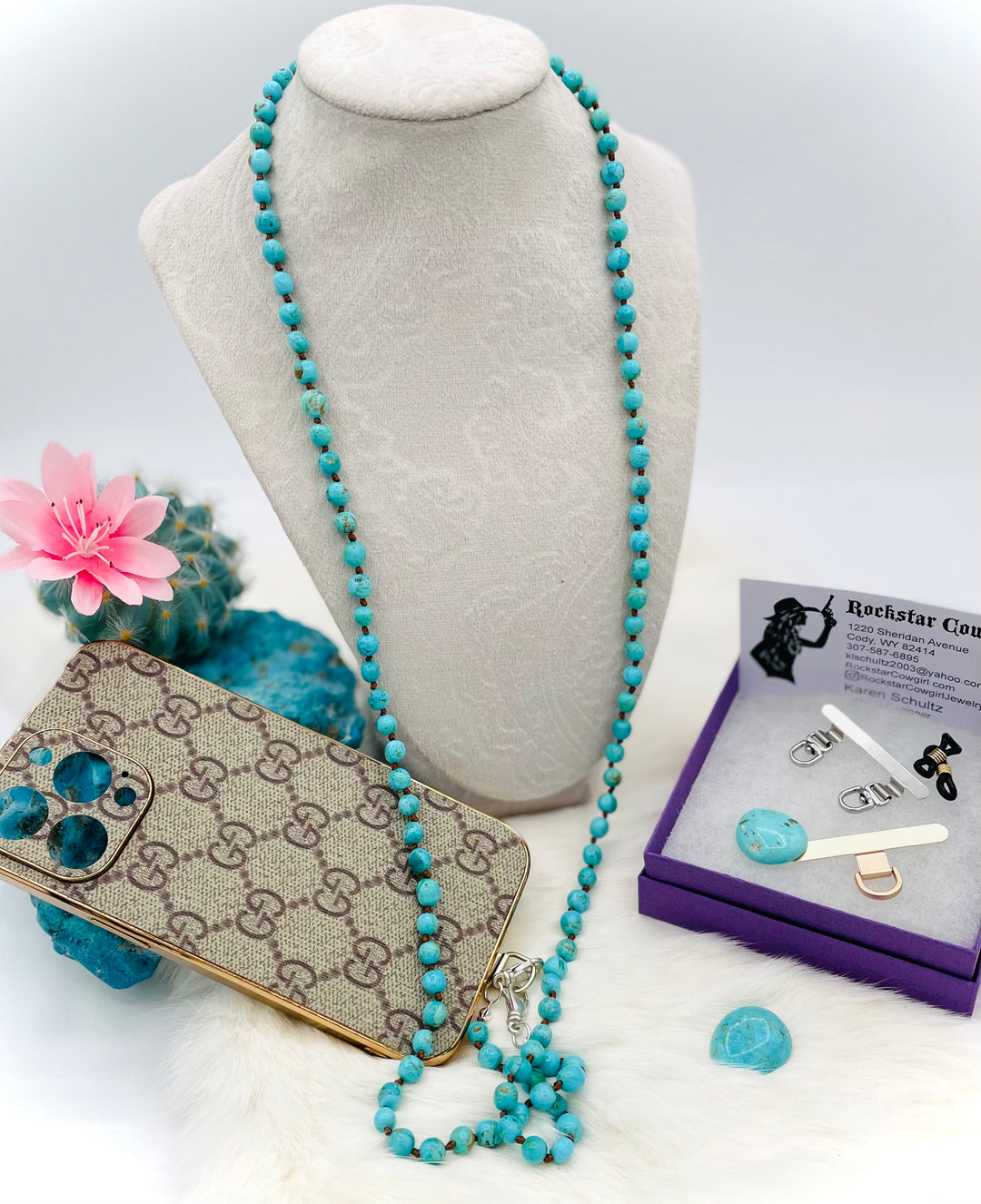 Silk knotted Kingman turquoise necklace, phone holder strap, or eyeglass holder featuring sterling silver swivel lobsters for various attachments or uses. Comes with phone case attachments and eye glasses loops. Available only from Rockstar Cowgirl online or in store in Cody, Wyoming.