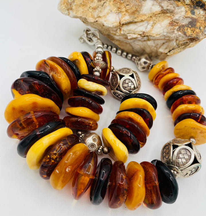 Beaded necklace featuring multi colored Baltic amber discs an handmade sterling silver beads. Available only from Rockstar Cowgirl online or in store in Cody, Wyoming.