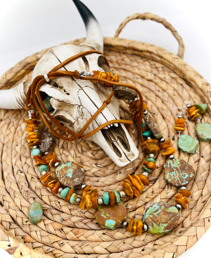 Beaded three strand necklace featuring Kingman turquoise, butterscotch amber, sterling silver beads, deer lace, and slide bead. Includes matching earrings. Available only from Rockstar Cowgirl online or in store in Cody, Wyoming.